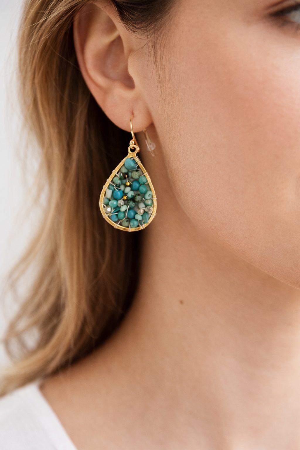tiny turquoise earring on model