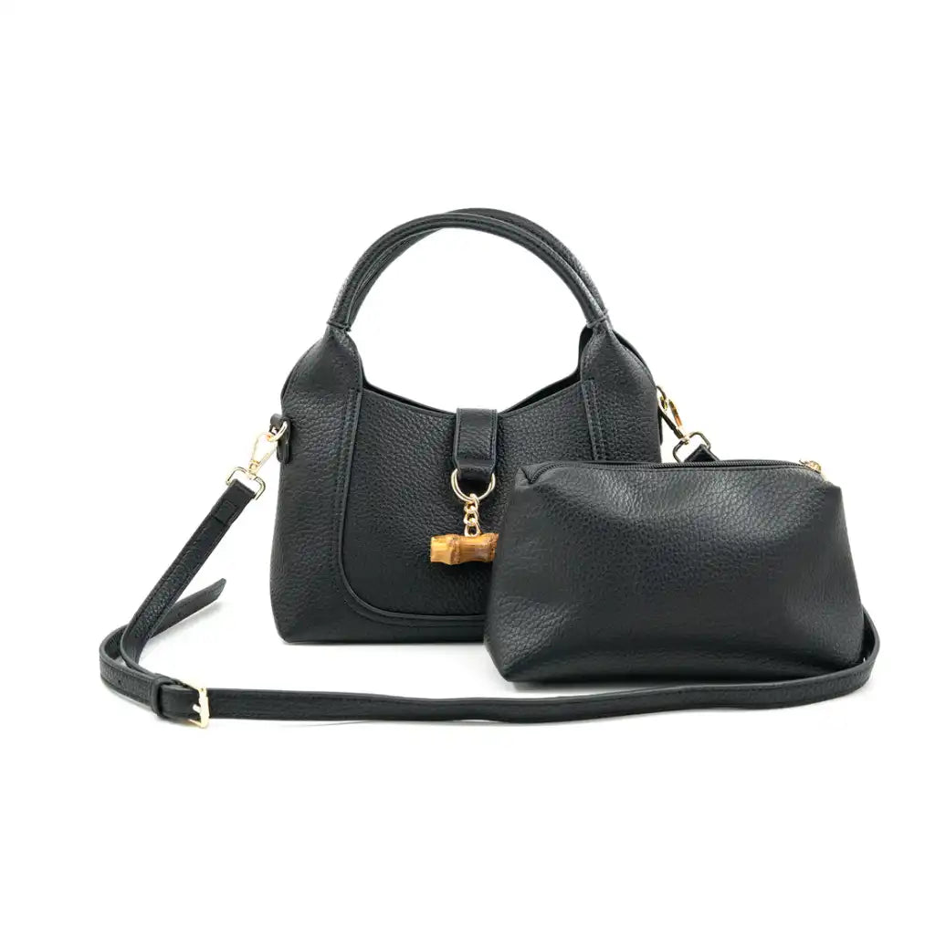 Black vegan leather handbag with matching pouch on a white background
