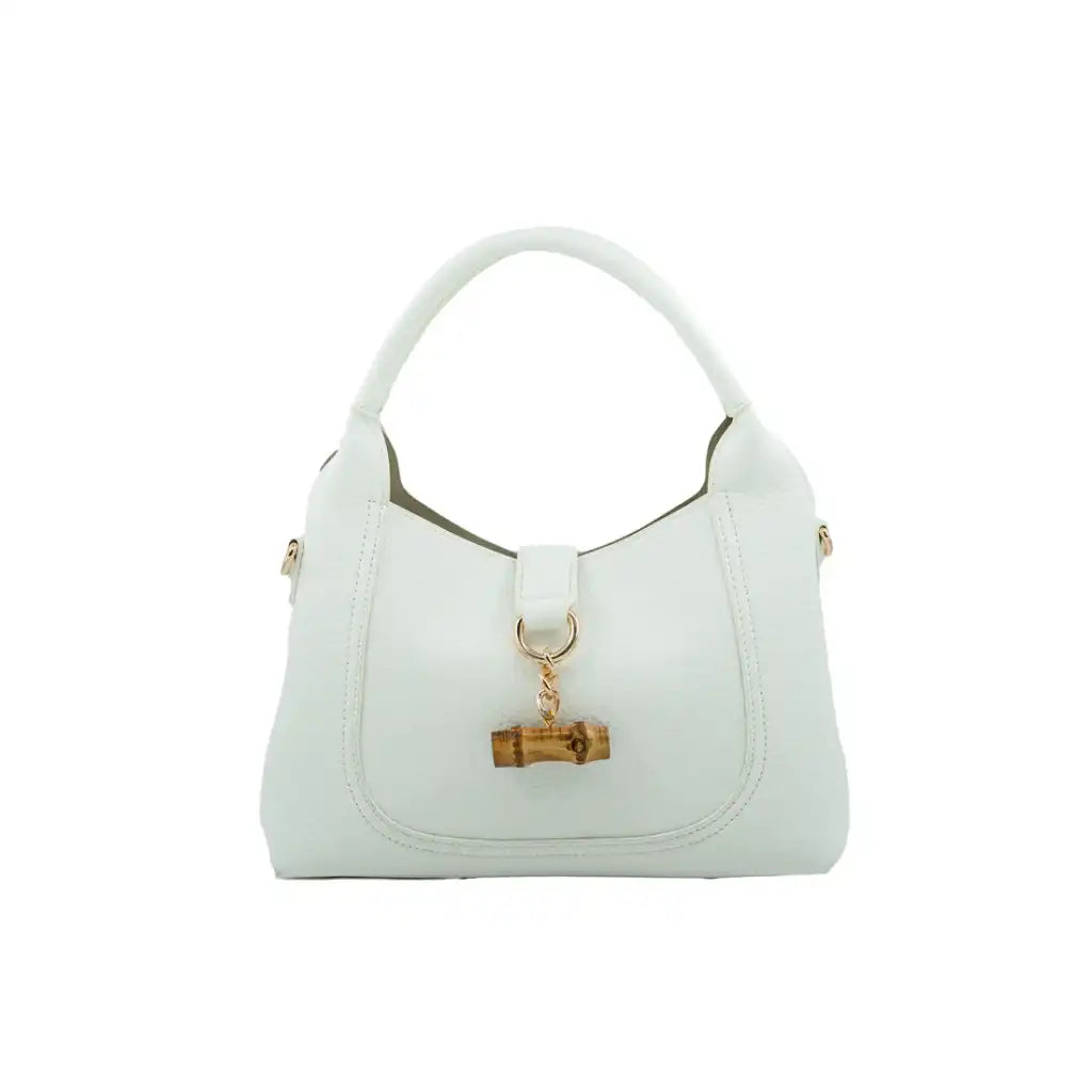 milan white vegan leather handbag with a gold bamboo charm on a white background