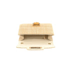 woven clutch with bamboo toggle closure on white background